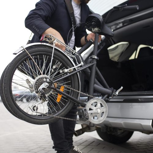 young-man-using-folding-bike-city